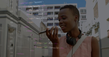 Dictating voice message woman with headphones holding smartphone on urban street, with code overlay. Technology, communication, urban, casual, digital, modern, creativeの写真素材