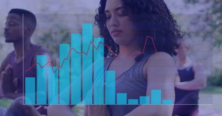 Woman in gray sleeveless top meditating in park, with translucent blue bar chart and red line. Wellness, serenity, mindfulness, nature, harmony, tranquility, outdoorの写真素材