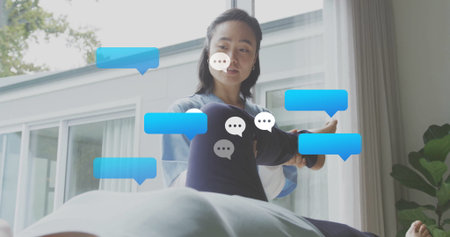 Stretching client's leg therapist in scrubs standing by massage table in clinic, with chat bubbles. Health, wellness, rehabilitation, physiotherapy, modern, clean, professionalの写真素材