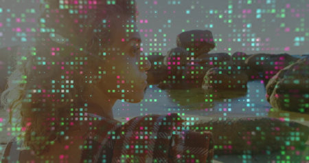 Leaning woman wearing jacket gazing at boulders in calm sea shore, with digital grid, copy space. Portrait, tranquility, ambient, modern, outdoor, reflective, technologyの写真素材