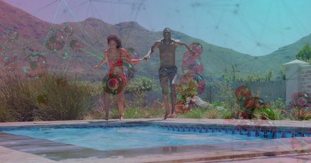 Jumping couple holding hands and leaping into backyard pool in bikini and swim trunks. Recreation, leisure, summery, outdoor, waterfun, candid, energeticの写真素材