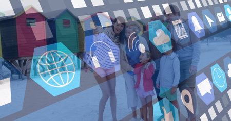Smiling extended family posing at shoreline, with smartphone, colorful beach huts and digital icons. Family, leisure, coastal, technology, communication, multigenerational, vibrantの写真素材