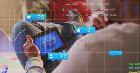 Analyzing man using tablet while viewing blueprint and social icons in home lounge, copy space. Futuristic, innovation, digital, analytics, socialmedia, technology, casualの写真素材