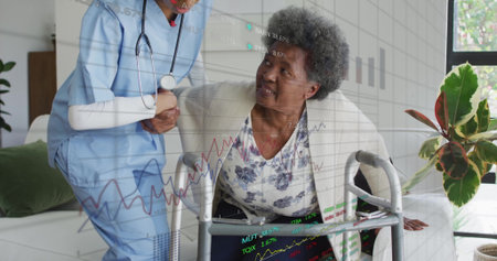 Supporting caregiver in scrubs guiding senior patient rising from green sofa at home, with walker....