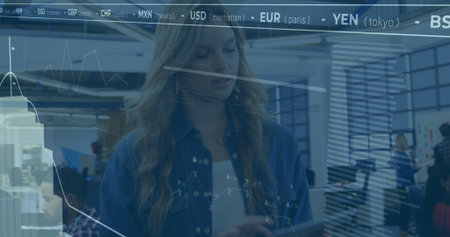 Holding tablet and viewing financial charts, analyst working at modern office, with glass walls. Technology, collaboration, modern, professional, startup, interface, dataの写真素材