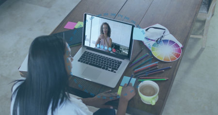 Joining designer working in design meeting at home studio, using laptop, color fan deck, copy space....