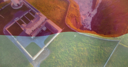 Showing lighthouse compound sitting inside white walls on clifftop, winding path and waves. Coastal, landscape, nautical, maritime, scenic, aerial, naturalの写真素材