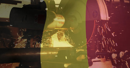 Grinding metal pipe on bench grinder at metal workshop, with shower of sparks nearby. Abrasive,...