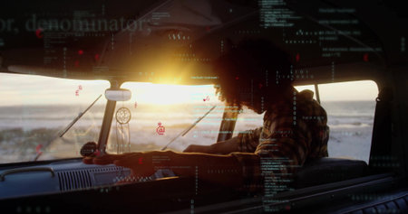 Driving man gripping wheel inside camper van at beach sunset, with dreamcatcher and code overlay....