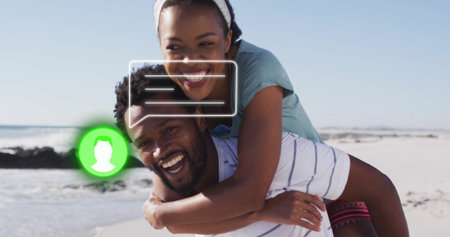 Couple wearing beach clothes giving piggyback ride at shore, with chat bubble and green user icon....