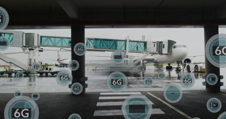 Airplane docking at boarding bridge in airport gate corridor with wet zebra markings and 6G icons....