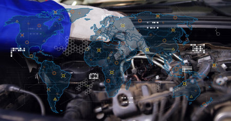 Grasping gloved hand in uniform adjusting engine components in shop, with digital world map overlay....