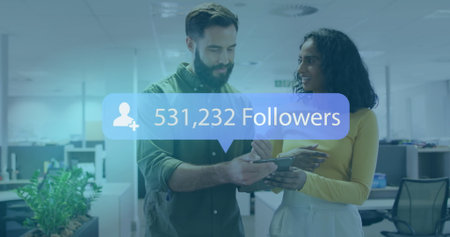 Office colleagues reviewing handheld device displaying follower count in modern office, with plant. Collaboration, productivity, technology, workspace, innovation, teamwork, corporateの写真素材