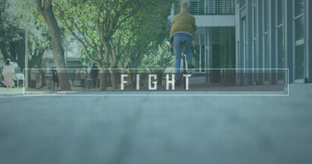Cycling man wearing tan jacket and jeans along campus path, with bicycle and backpack FIGHT overlay....