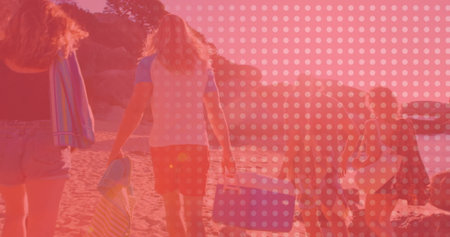 Walking five friends carrying beach gear along sandy shoreline by cliffs, with blue portable cooler. Coastline, leisure, outdoor, relaxation, adventure, vibrant, naturalの写真素材