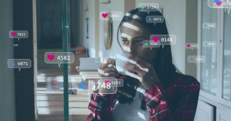 Sipping woman in red plaid holding white mug in kitchen, with social media icons, copy space....