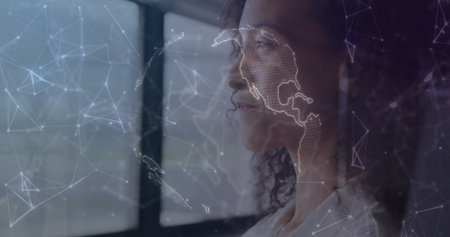 Gazing businesswoman wearing white blouse viewing network map overlay at office window, copy space....