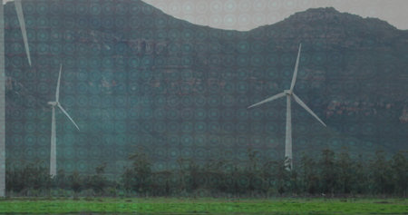 Spinning white wind turbines producing energy in grassy pasture at mountain ridge, shrubs bordering....