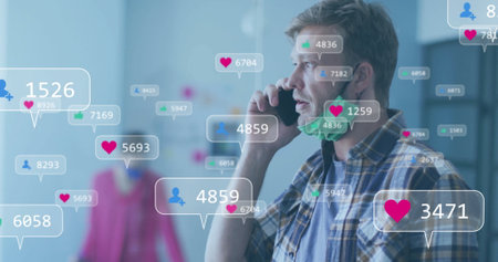 Holding smartphone to ear man in plaid shirt speaking in showroom, with mask and notification icons....