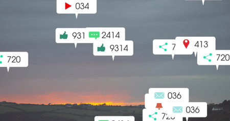 Displaying social media speech-bubble icons showing likes comments shares over fields at dusk....