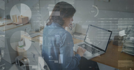 Analyzing data overlays, woman in denim shirt and headset working at desk in office, with folders....