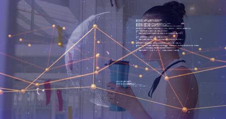 Analyzing Asian woman engaging with data overlay behind glass wall, with blue insulated travel mug....