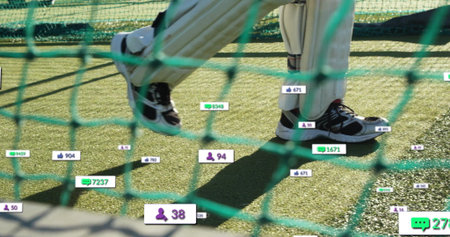 Capturing player wearing cricket pads and shoes standing on turf in net, with engagement icons....