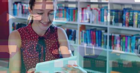 Girl wearing red blouse reading white tablet at wooden table in study room, with bookshelves....