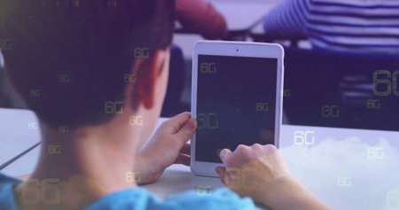 Tapping boy wearing blue T-shirt tapping white tablet screen at school classroom, with 6G symbols....