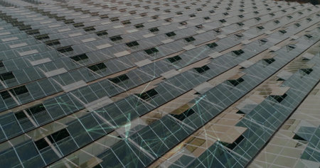 Spanning photovoltaic panels stretching across solar farm grid, with metal rails and supports....