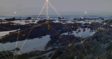 Showing rocky outcrops, tide pools holding reflective water at shore, with golden nodes and lines....
