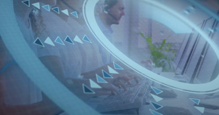 Typing agents wearing headsets at open-plan office desk with keyboards, plant and network overlay....