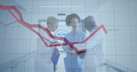 Doctors and nurse reviewing tablet clipboard in hospital hall, with stethoscope and red line graph....