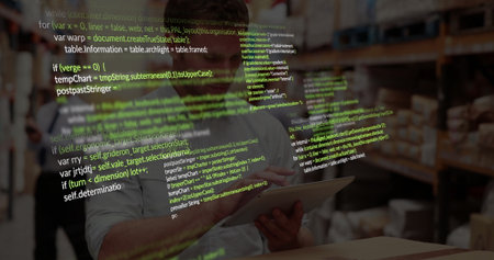 Scanning racks and boxes, employee wearing white shirt and hard hat using tablet inside warehouse. Inventory, logistics, technology, industrial, organization, teamwork, efficiencyの写真素材