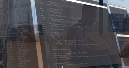 Developer wearing shirt and glasses typing code in office, with 3 screens showing JavaScript code. Technology, screen, workspace, programming, innovation, modern, concentrationの写真素材