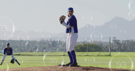 Pitching female baseball player gripping ball from clay mound at field, with floating 5G icons....