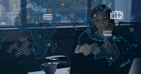 Woman analyst analyzing world map projection at office desk, with laptop and coffee mug, copy space....