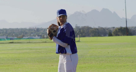 Positioning female baseball player pitching ball on grass field, wearing blue cap and leather glove....