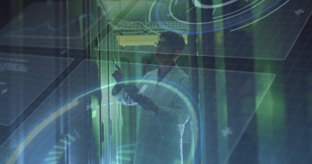 Pointing man wearing white lab coat checking server modules in data center, with HUD graphics....