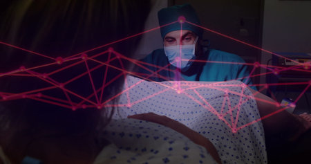 Examining doctor leaning over patient in patterned gown on hospital bed, with red digital overlay. Medical, healthcare, diagnostics, technology, innovation, professionalism, clinicalの写真素材
