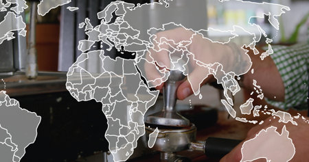 Barista wearing green shirt pressing grounds with tamper in portafilter at cafe, world map overlay....