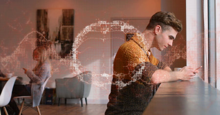 Leaning male wearing rust sweater using smartphone at cafÃ© counter with graphic overlay, copy...