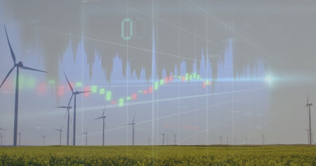 Spinning white wind turbines harnessing wind power on yellow field, with translucent market charts....