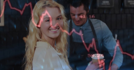 Smiling customer holding paper cup at coffee bar, with striped apron behind financial graph overlay. Cafe, analytics, finance, technology, service, modern, businessの写真素材