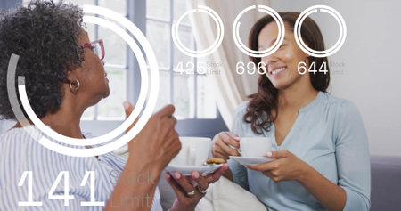 Mother and daughter holding teacups with biscuits and viewing floating data overlays in living room. Family, companionship, comfort, modern, technology, relaxation, casualの写真素材