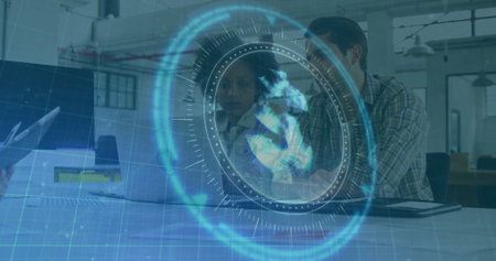 Discussing colleagues reviewing project data on laptop in open-plan office, with holographic globe. Collaboration, technology, innovation, teamwork, modern, professional, digitalの写真素材