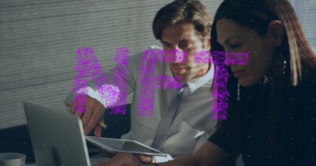 Collaborating mid adult duo reviewing documents with pen at office desk, with laptop and coffee mug. Business, teamwork, innovation, productivity, modern, corporate, communicationの写真素材