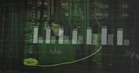 Monitoring data center systems, hooded Korean typing on laptop, with yellow cable and server racks. Technology, cybersecurity, network, digital, infrastructure, analysis, monitoringの写真素材