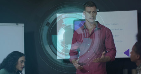 Presenting man in red shirt showing holographic overlay on monitor in office meeting room. Technology, collaboration, innovation, teamwork, digital, modern, brainstormingの写真素材