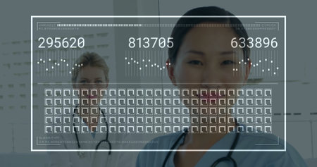 Smiling doctor in blue scrubs reviewing codes on overlay in hospital with stethoscope, copy space. Medical, healthcare, technology, digital, futuristic, professional, clinicalの写真素材
